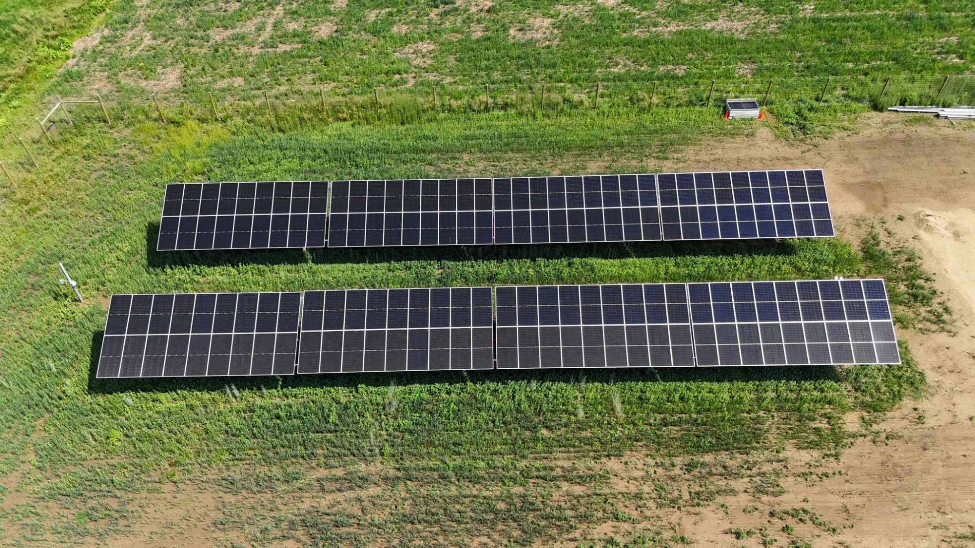 Elevated solar array structure with wide interrow spacing and vegetation